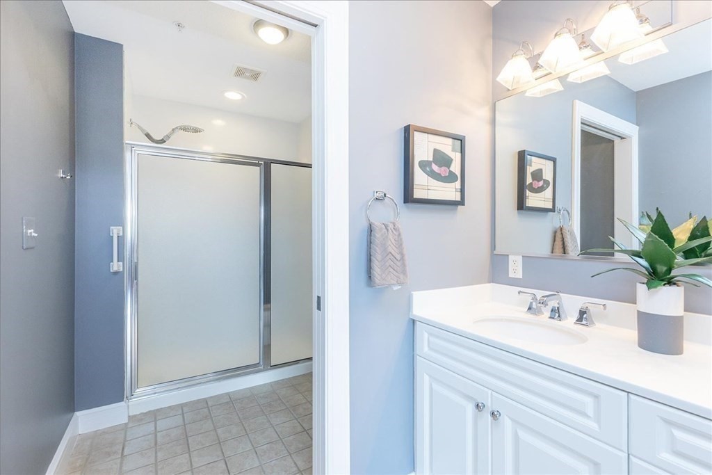 36 Village Road, Unit 706 Middleton, MA 01949 - Photo 30 of 42 a bathroom with a sink and a mirror