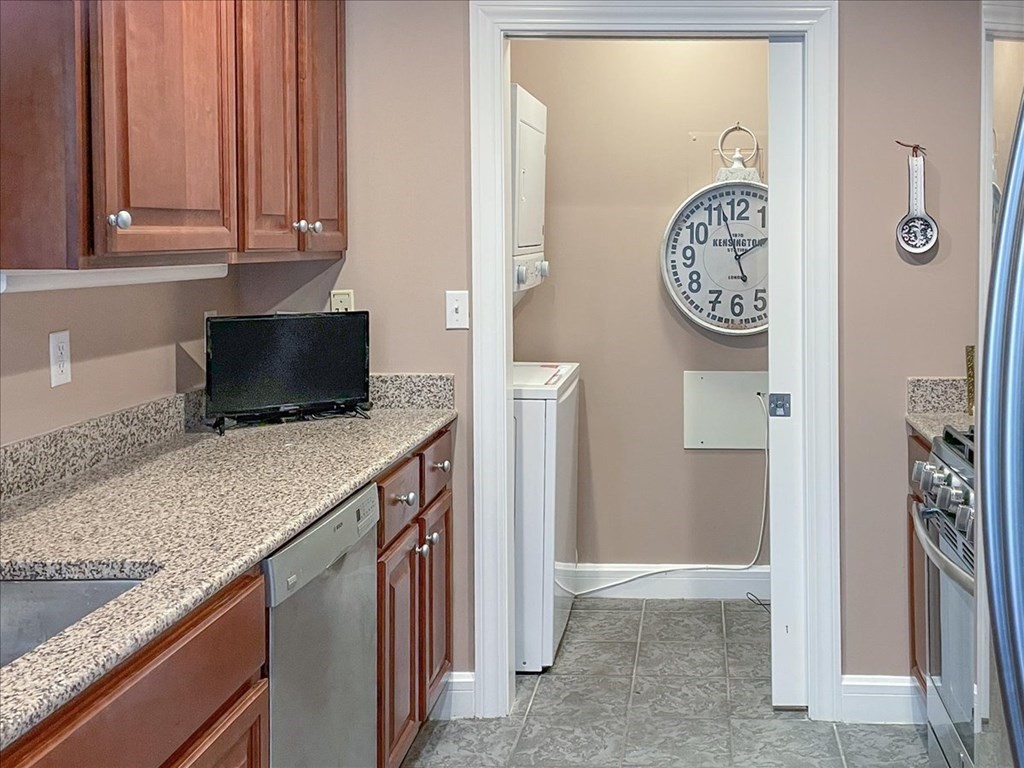 36 Village Road, Unit 706 Middleton, MA 01949 - Photo 10 of 42 a kitchen with a refrigerator and a stove