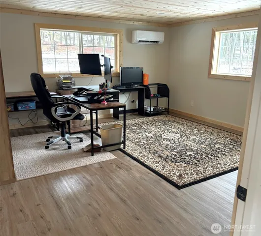 a view of a workspace with furniture and a window