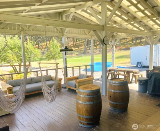 a living room with furniture and a floor to ceiling window