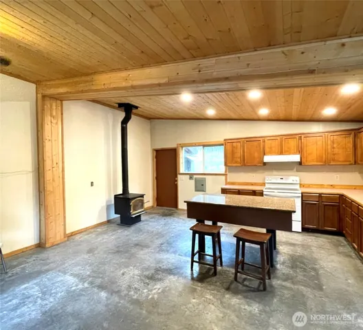a view of a kitchen with kitchen island a counter tops pace a sink and cabinets