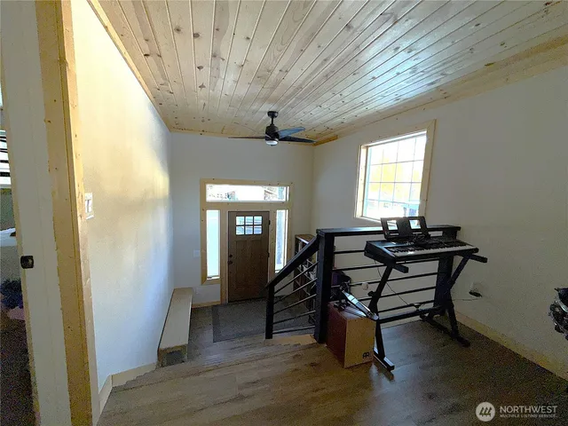 a view of a livingroom with furniture and a window