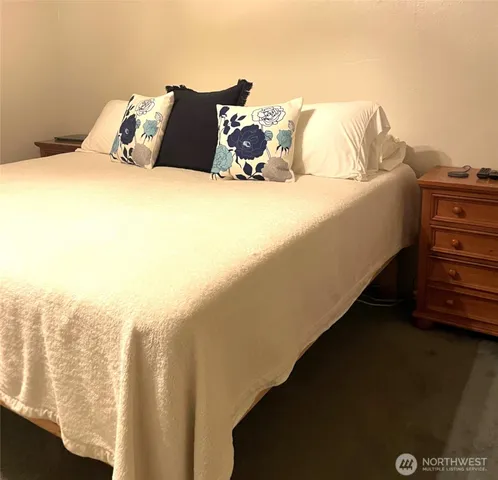 a bed sitting in a bedroom next to a window