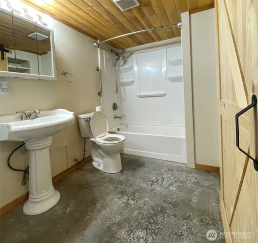 a bathroom with a sink toilet and shower