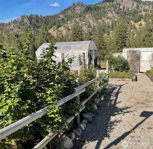 a view of a yard with wooden fence