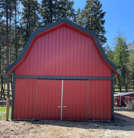 a view of small wooden house with wooden fence