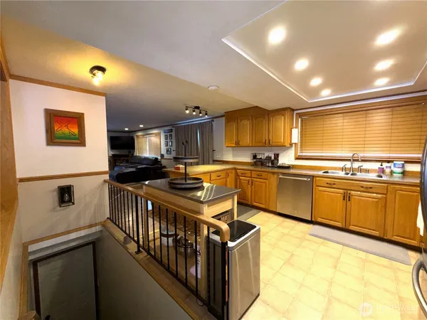 a kitchen with stainless steel appliances granite countertop a sink and cabinets