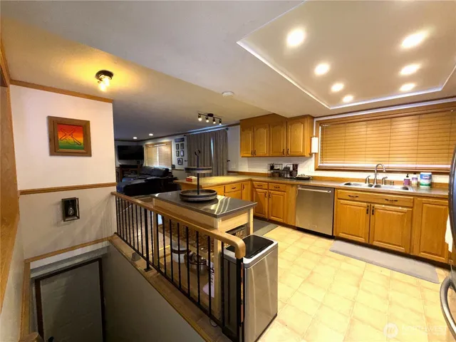 a kitchen with stainless steel appliances granite countertop a sink and cabinets