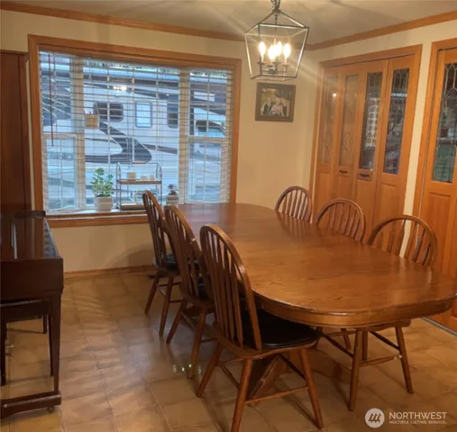 a view of a dining room with furniture and chandelier