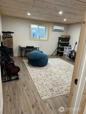 a bedroom with furniture and a wooden floor