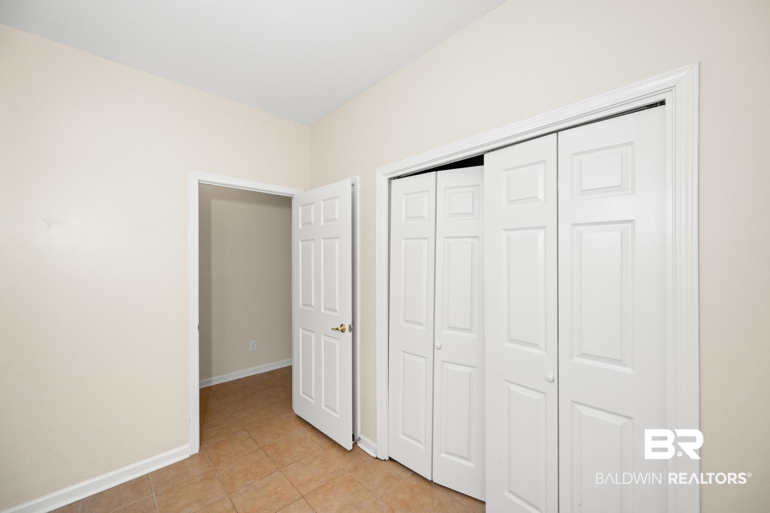 1333 Dominoe Trail Foley, AL 36535 - Photo 15 of 32 Unfurnished bedroom with light tile patterned floors and a closet