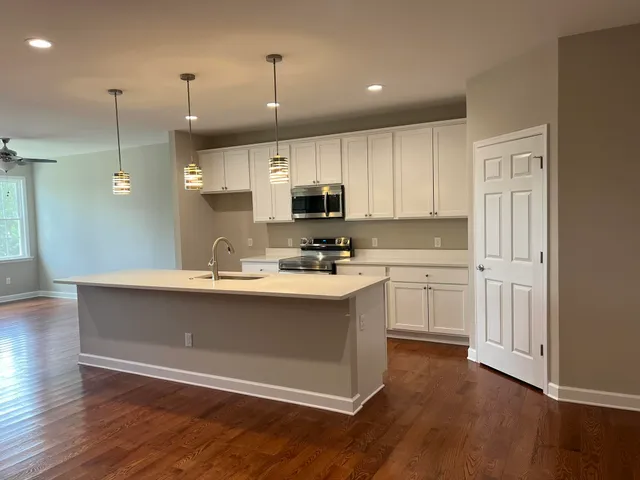 a view of hallway with wooden floor