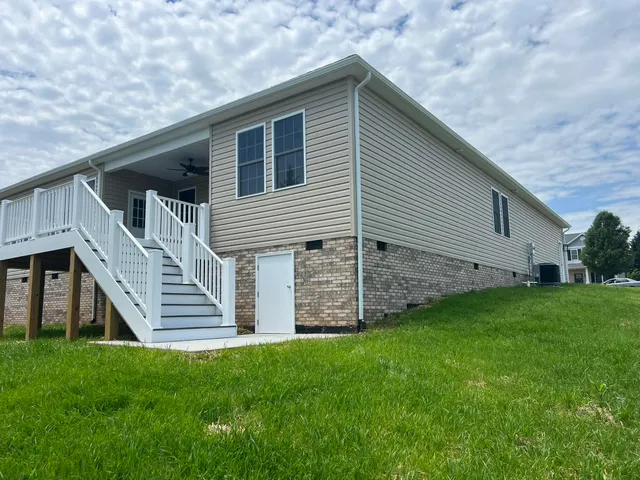 a large kitchen with cabinets wooden floor and stainless steel appliances