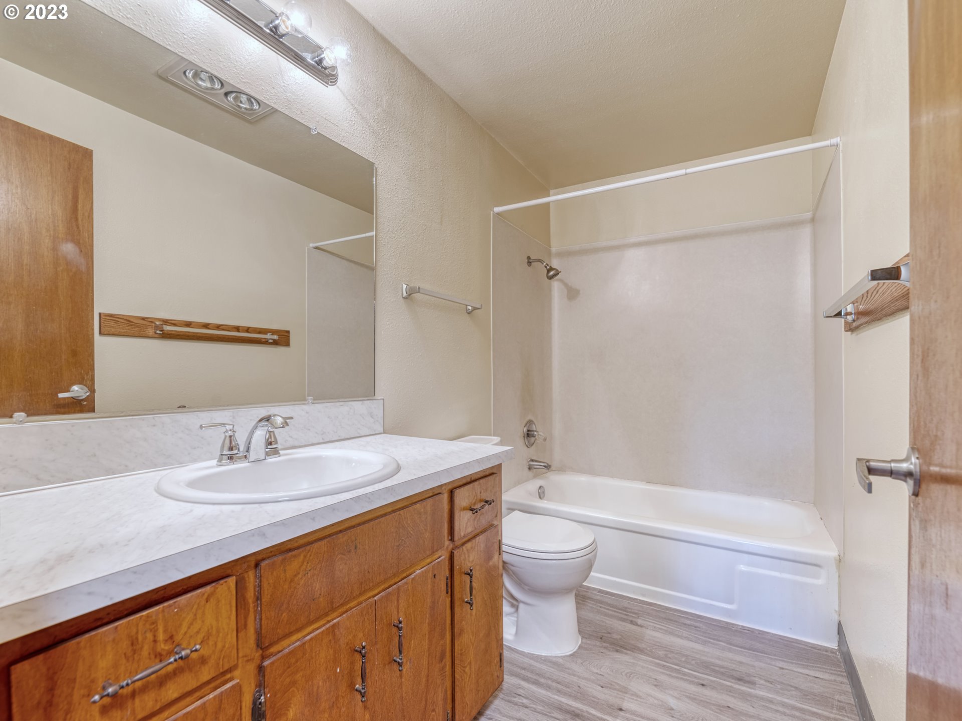1249 6th Street Springfield, OR 97477 - Photo 16 of 24 a bathroom with a granite countertop sink toilet and shower