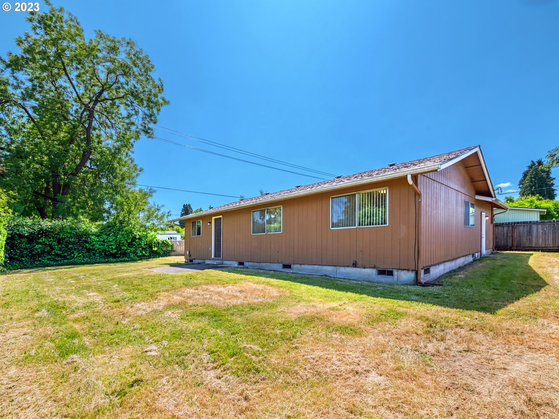 1249 6th Street Springfield, OR 97477 - Photo 20 of 24 a view of a house with yard and a tree