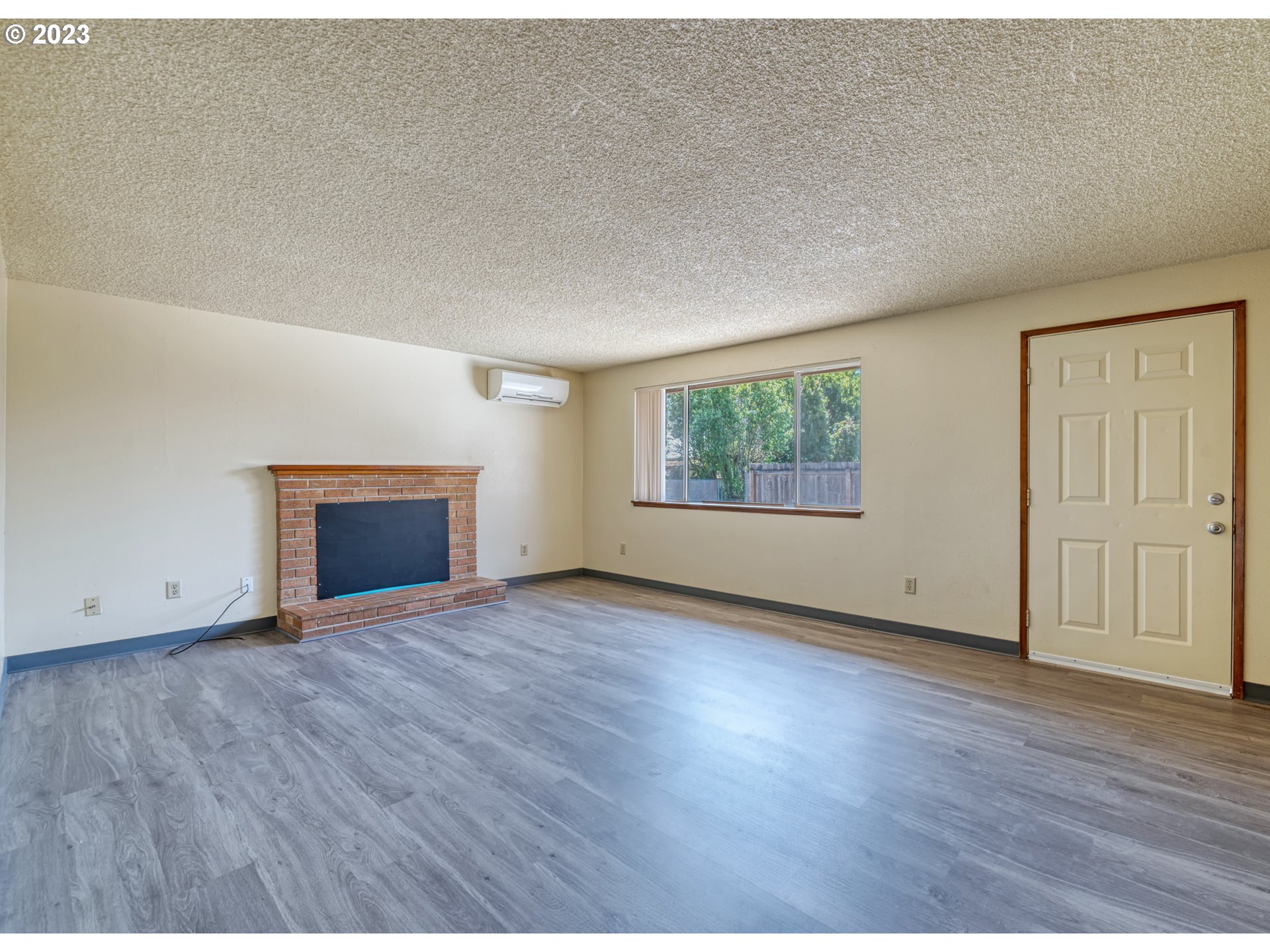 1249 6th Street Springfield, OR 97477 - Photo 4 of 24 a view of an empty room with wooden floor and a window
