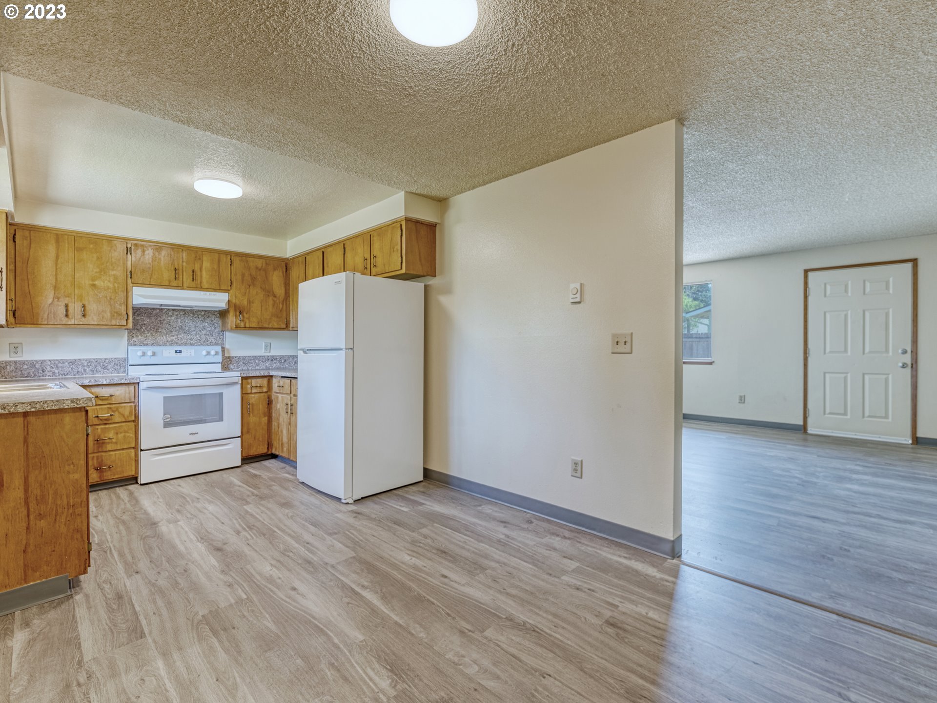 1249 6th Street Springfield, OR 97477 - Photo 8 of 24 a kitchen with a refrigerator a sink and cabinets