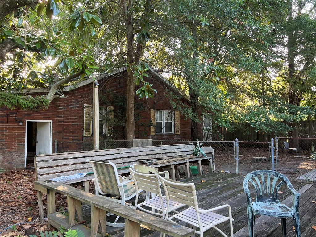 2017 Clinch Drive Fernandina Beach, FL 32034 - Photo 16 of 22 a view of a patio with table and chairs and wooden fence