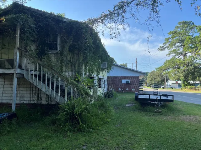 a view of a house with backyard and sitting area