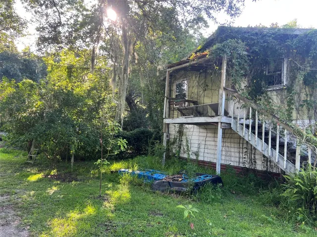 a view of a house with backyard and sitting area