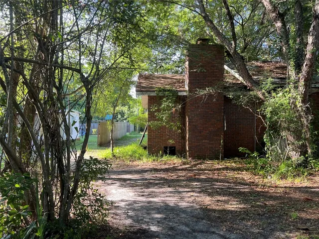 a view of house and tree in the background