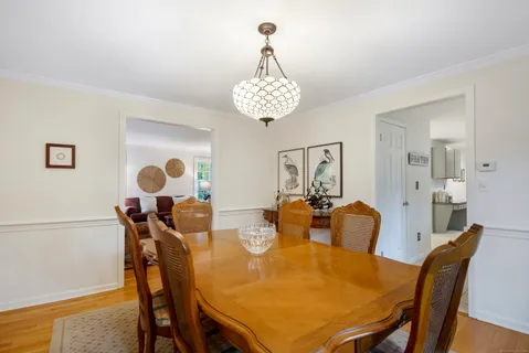 a view of a dining room with furniture and chandelier