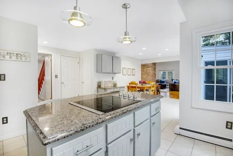 a kitchen with stainless steel appliances granite countertop a sink dishwasher and cabinets