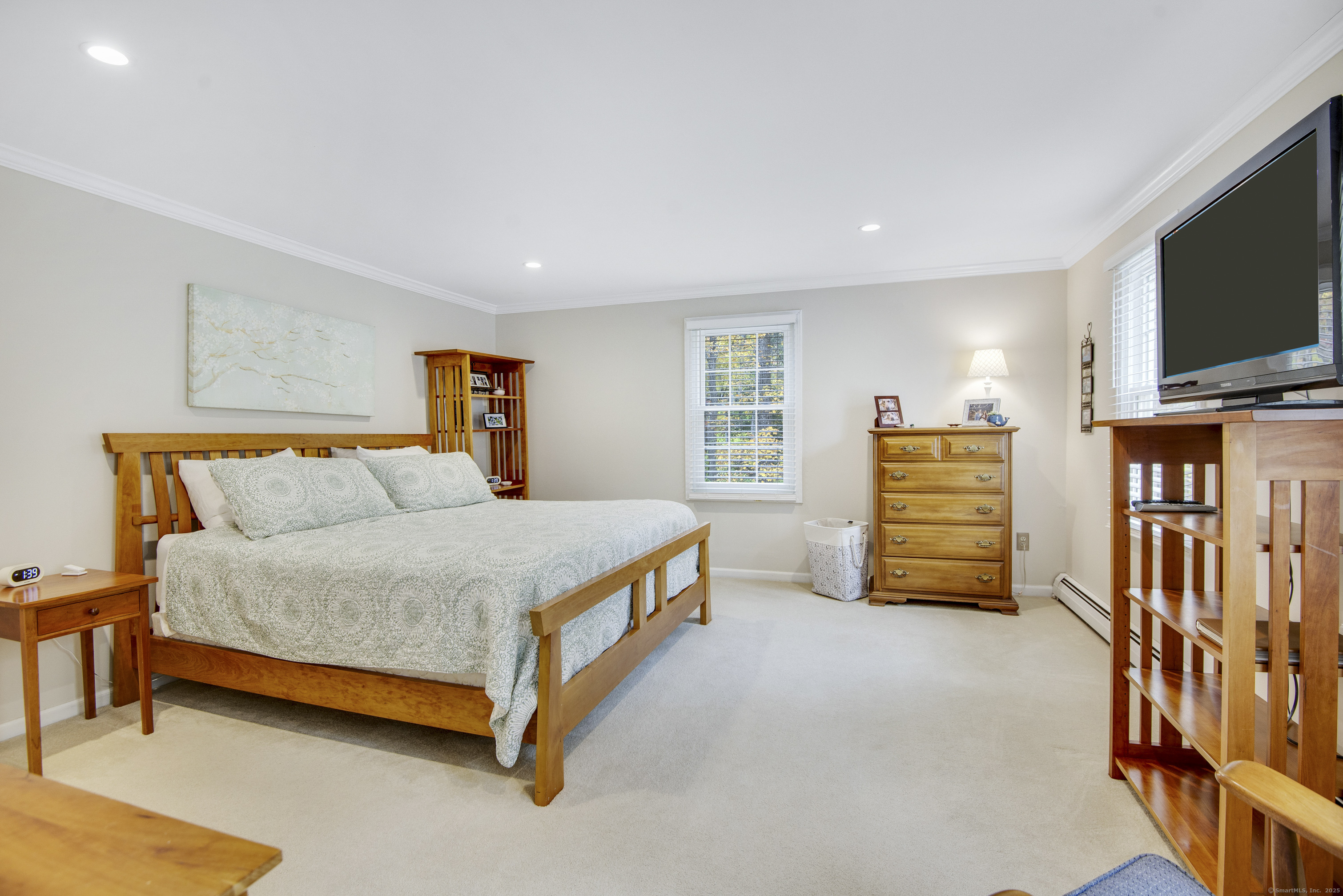 48 Bar Gate Trail Killingworth, CT 06419 - Photo 27 of 40 a spacious bedroom with a bed and a flat screen tv
