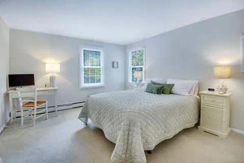 a bedroom with a bed and a lamp