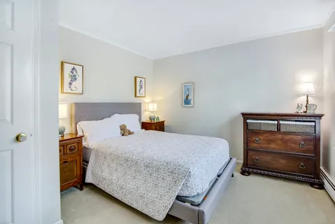 a bedroom with a bed and lamp