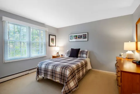 a bathroom with a granite countertop sink mirror vanity and toilet