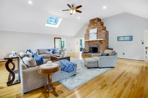 a living room with fireplace furniture and a chandelier