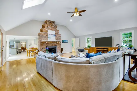 a living room with fireplace furniture and a flat screen tv