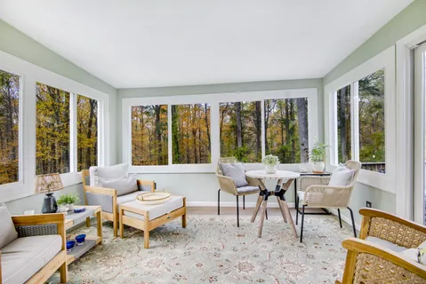 a living room with furniture and large windows