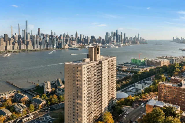 a living room with furniture a large window and kitchen view