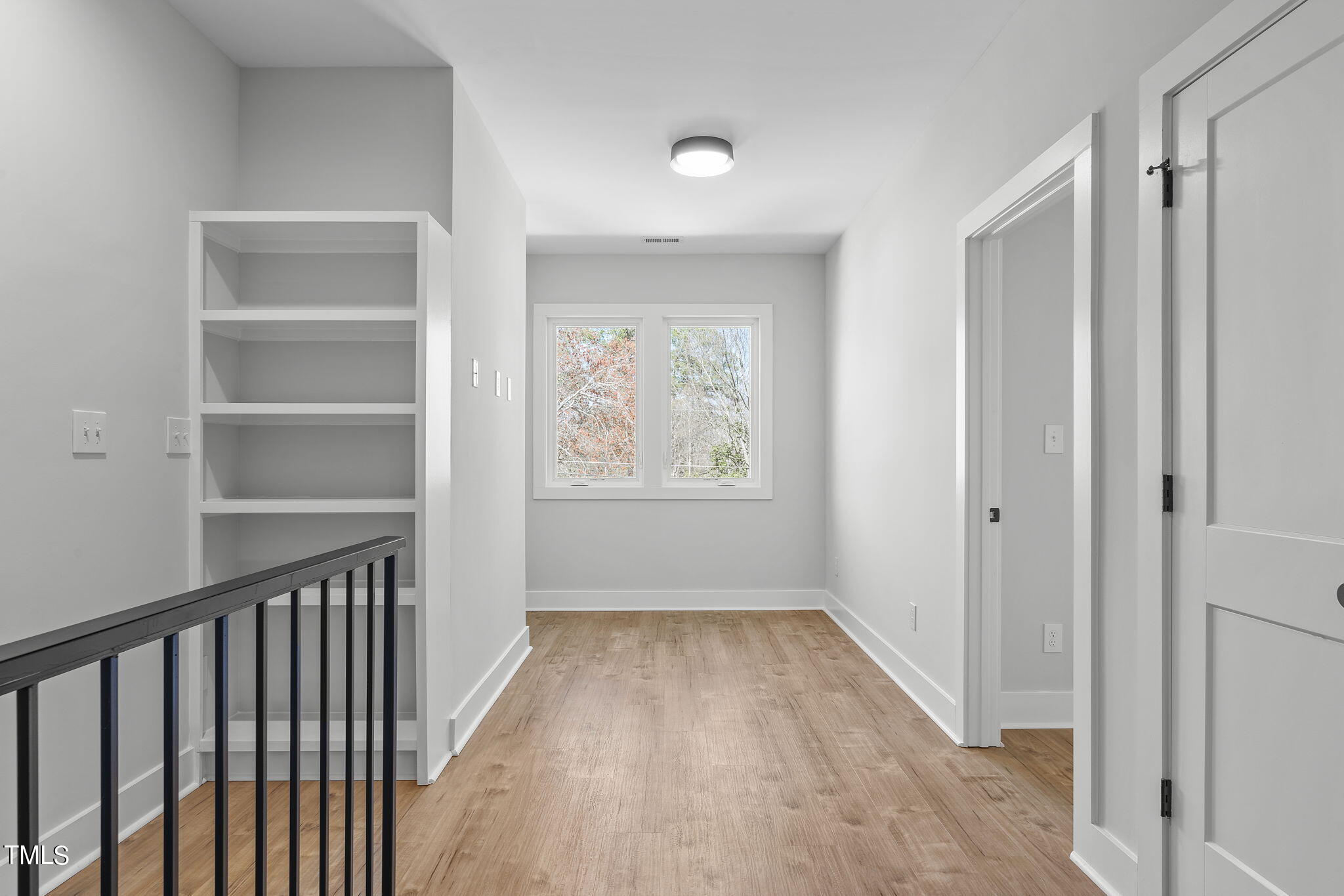 2232 Sheffield Road, Unit 102 Raleigh, NC 27610 - Photo 16 of 32 a view of hallway with wooden floor and fan