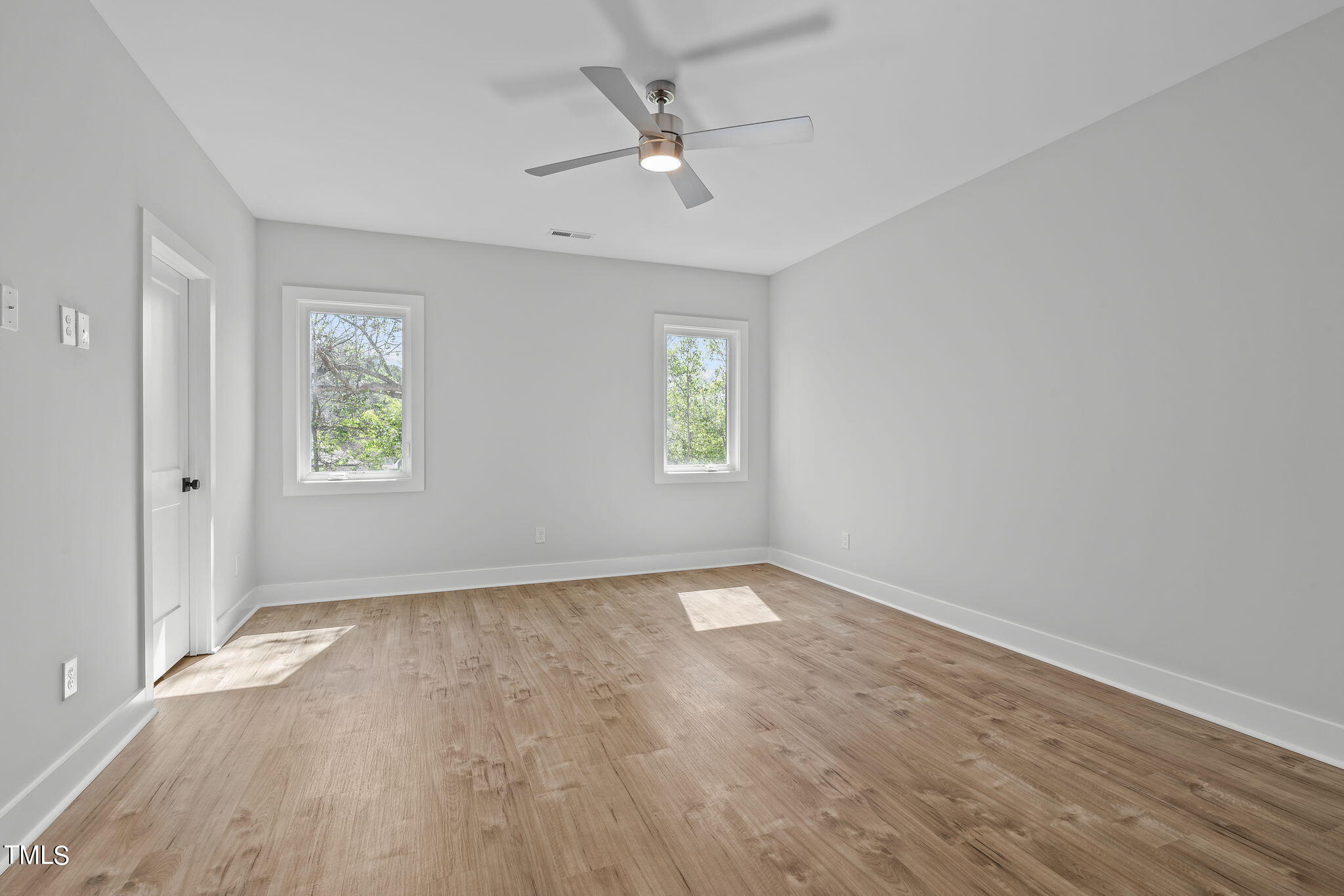 2232 Sheffield Road, Unit 102 Raleigh, NC 27610 - Photo 18 of 32 wooden floor in an empty room with a window
