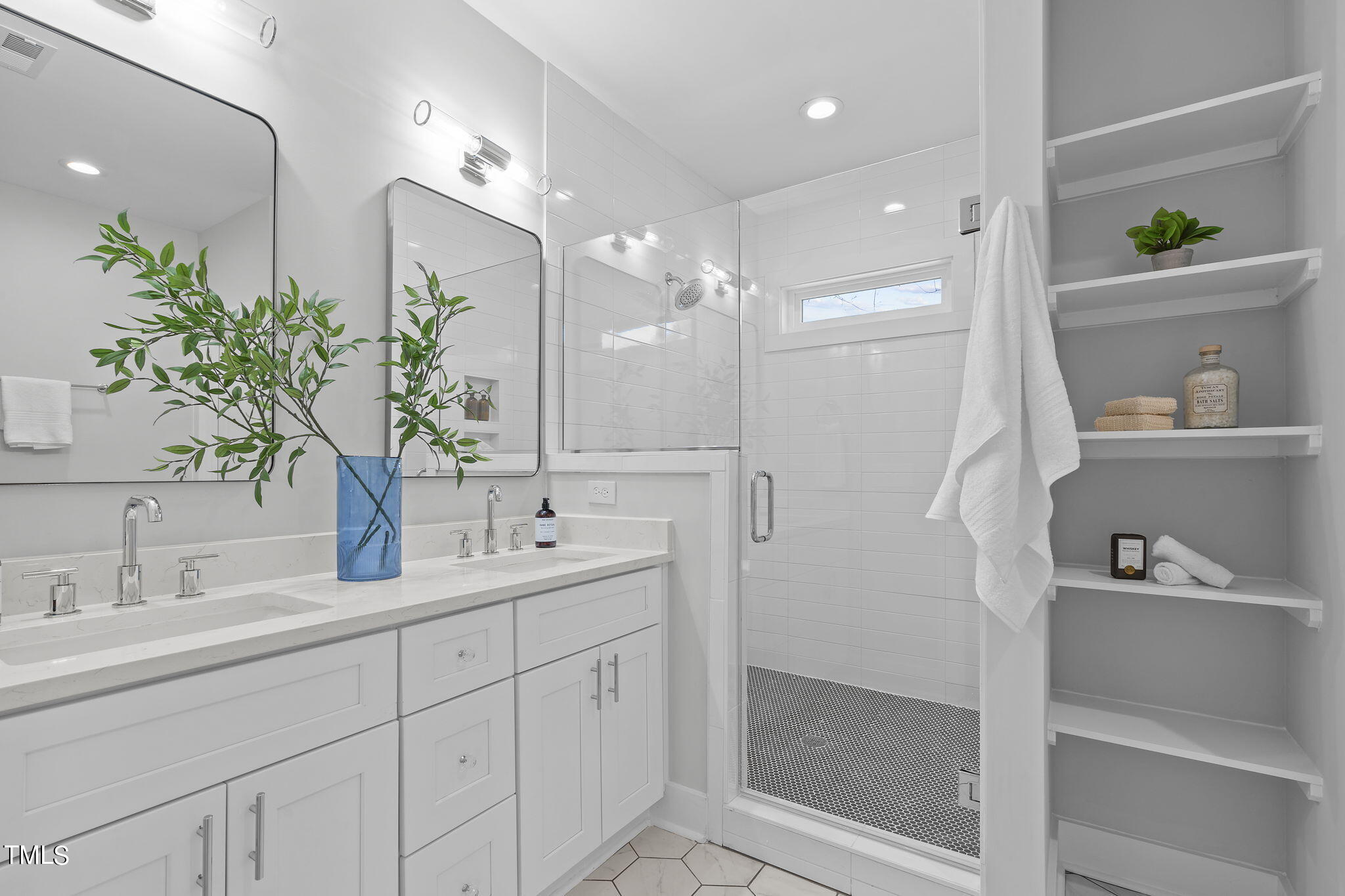 2232 Sheffield Road, Unit 102 Raleigh, NC 27610 - Photo 20 of 32 a bathroom with a shower sink and mirror