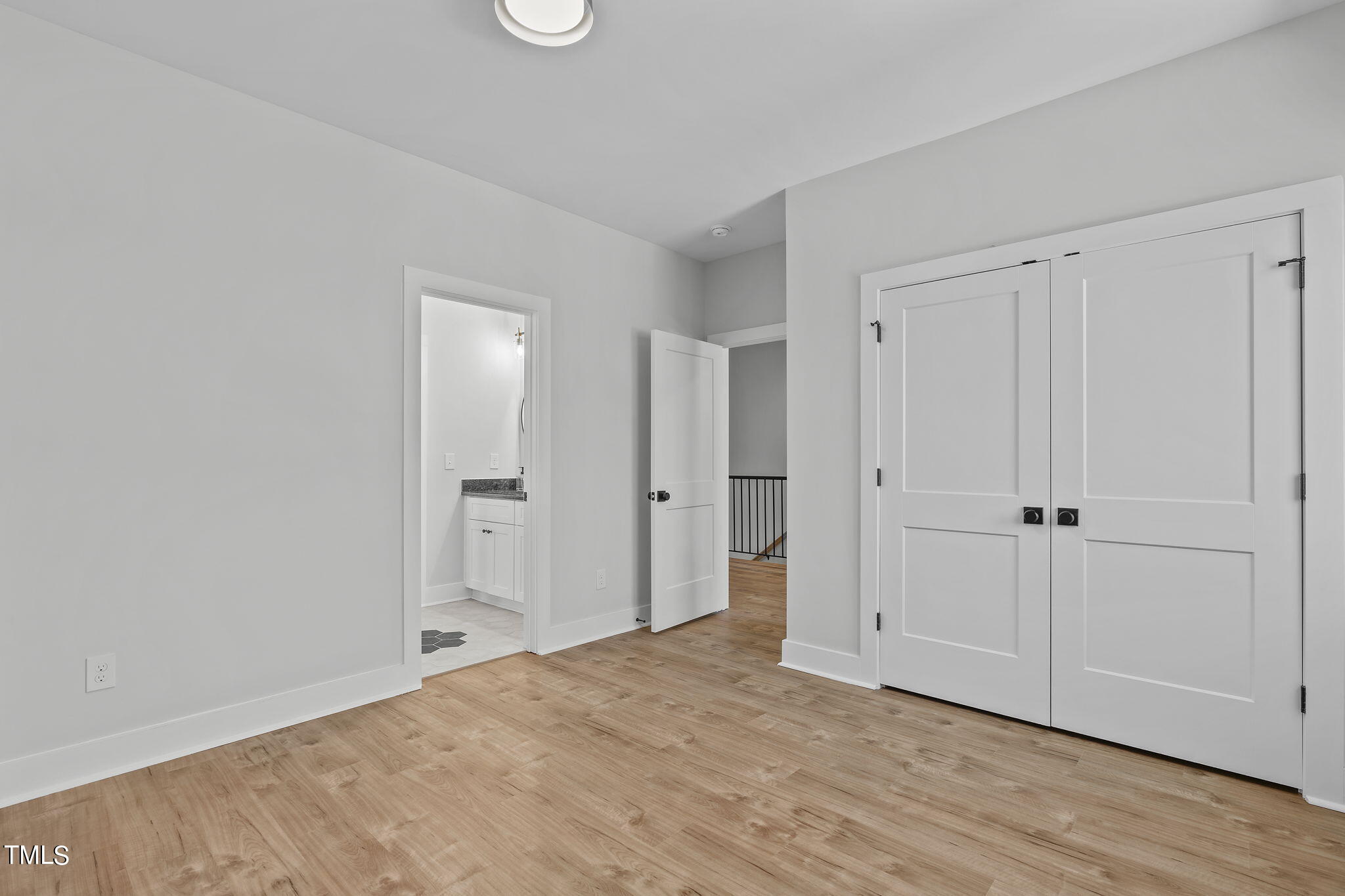 2232 Sheffield Road, Unit 102 Raleigh, NC 27610 - Photo 23 of 32 a view of a room with wooden floor and closet area