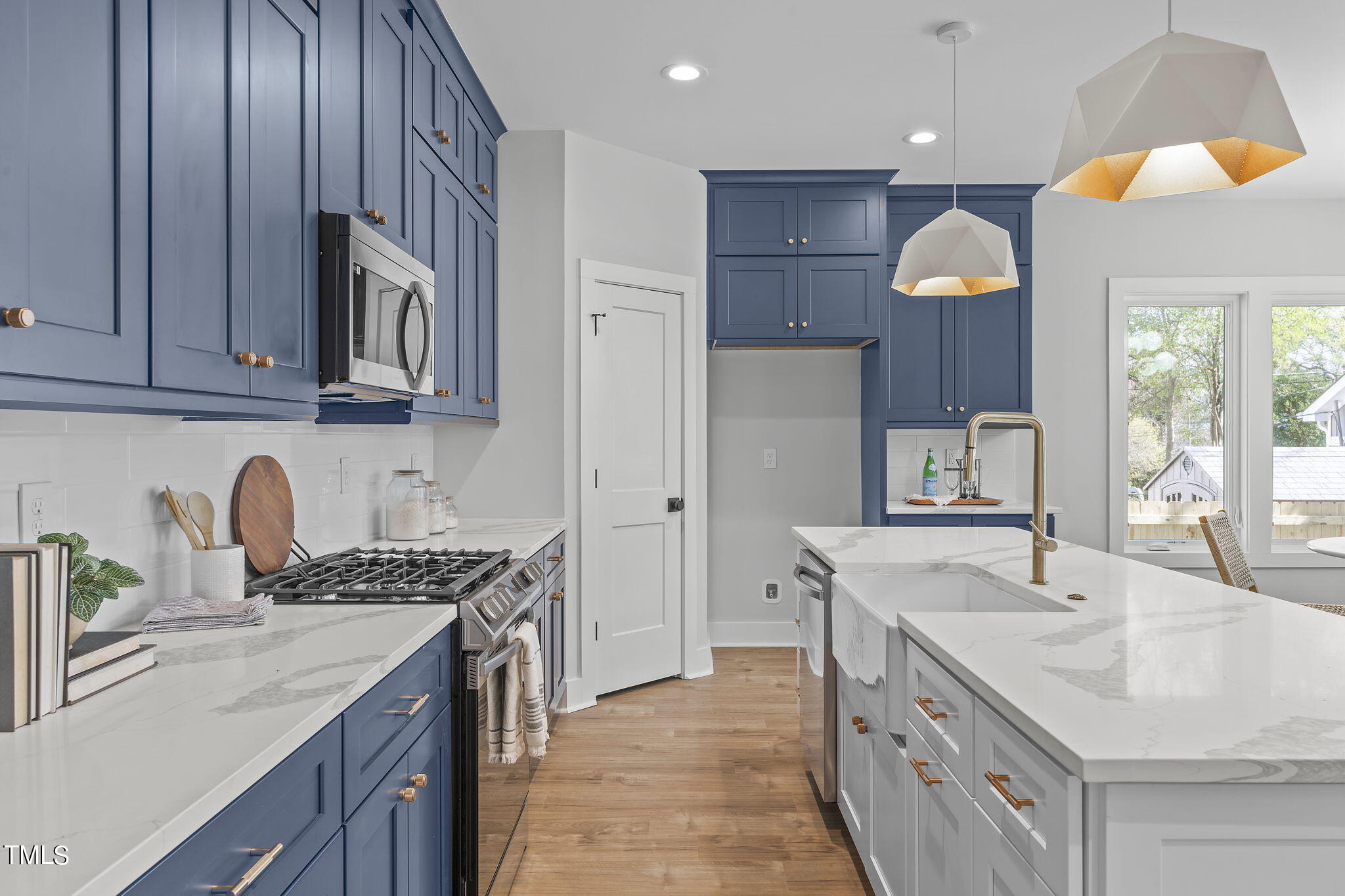 2232 Sheffield Road, Unit 102 Raleigh, NC 27610 - Photo 3 of 32 a kitchen with a sink stove top oven and cabinets