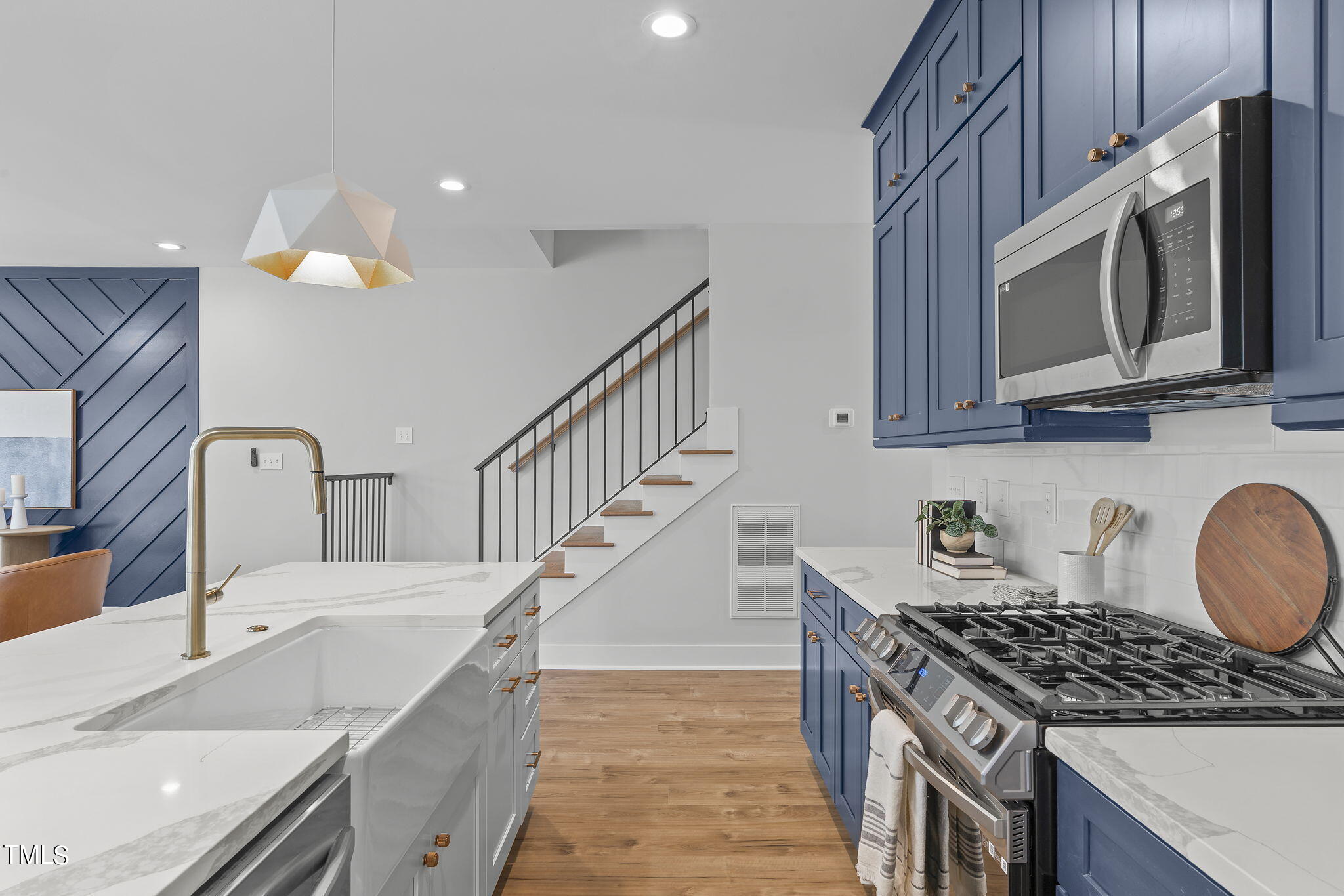 2232 Sheffield Road, Unit 102 Raleigh, NC 27610 - Photo 6 of 32 a kitchen with granite countertop a sink a stove top oven and cabinetry