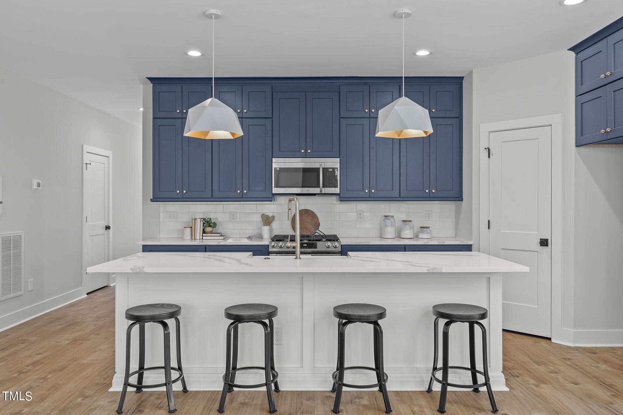 2232 Sheffield Road, Unit 102 Raleigh, NC 27610 - Photo 8 of 32 a kitchen with stainless steel appliances granite countertop a stove a sink dishwasher and a refrigerator with wooden cabinets