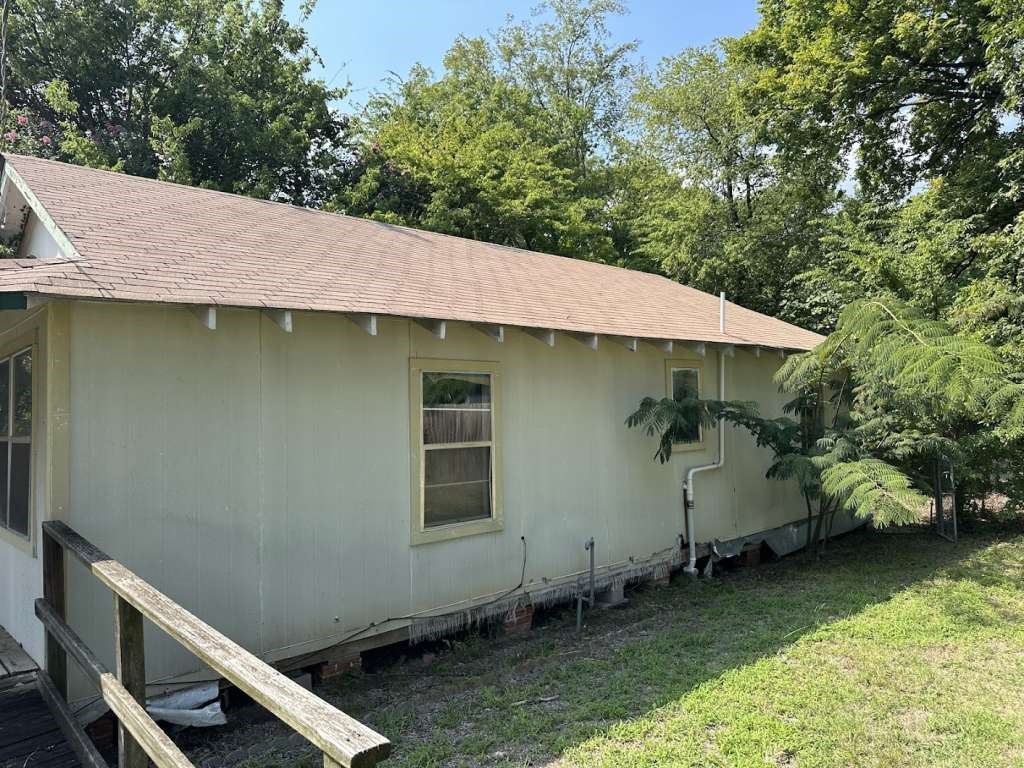 1311 West Grove Street Tyler, TX 75701 - Photo 4 of 12 a backyard of a house with large trees and table