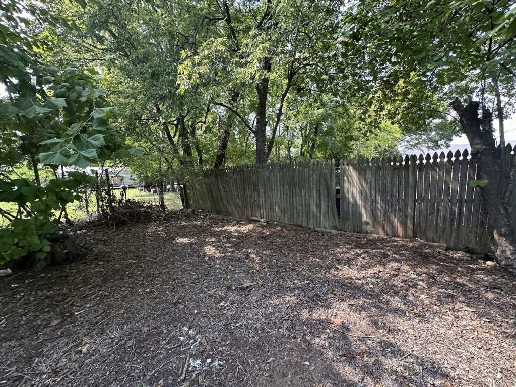 1311 West Grove Street Tyler, TX 75701 - Photo 5 of 12 a backyard of a house with lots of green space
