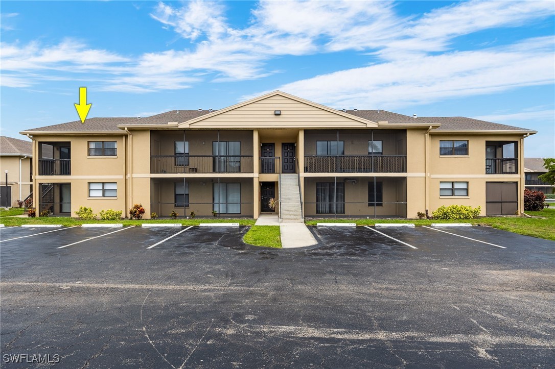 a front view of a residential apartment building with a yard