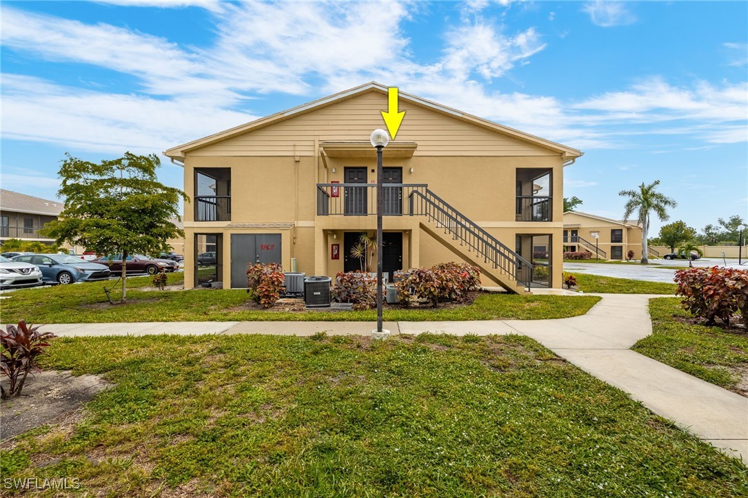 5315 Summerlin Road, Unit 1514 Fort Myers, FL 33919 - Photo 12 of 17 a view of a house with a yard