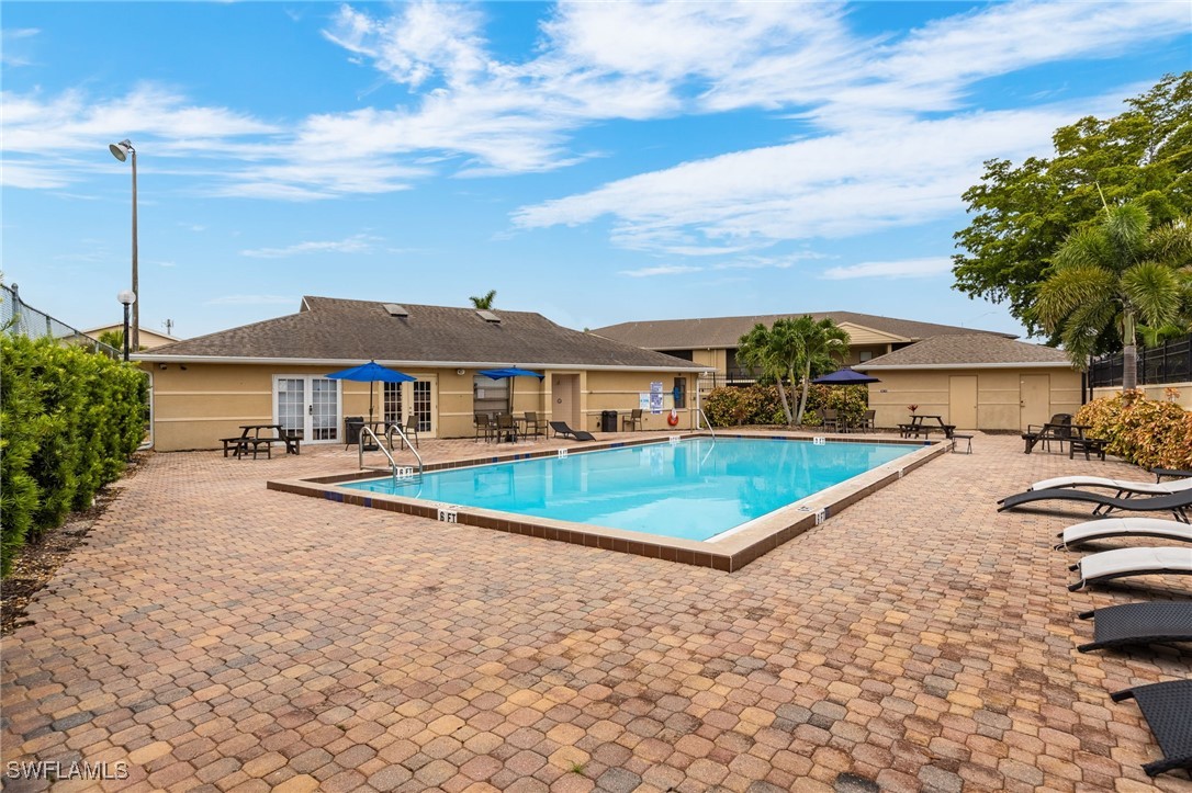 5315 Summerlin Road, Unit 1514 Fort Myers, FL 33919 - Photo 16 of 17 a view of a house with swimming pool and sitting area