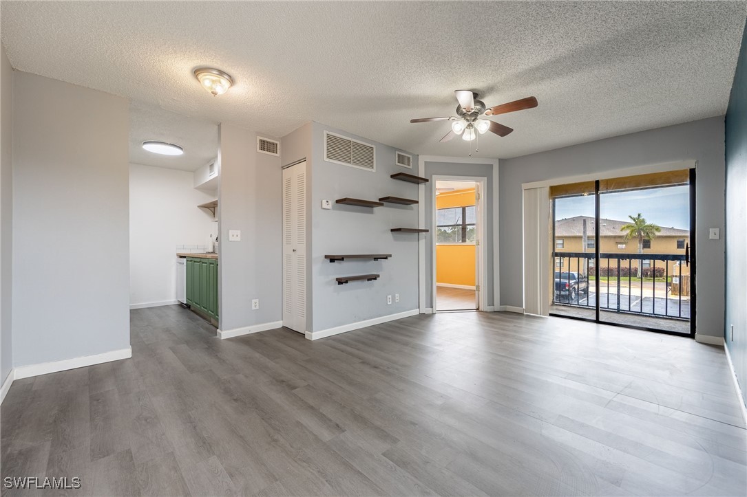5315 Summerlin Road, Unit 1514 Fort Myers, FL 33919 - Photo 2 of 17 a view of an empty room with a window and wooden floor