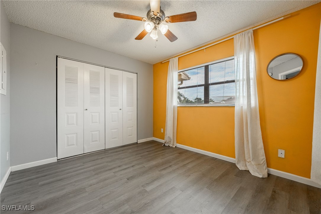 5315 Summerlin Road, Unit 1514 Fort Myers, FL 33919 - Photo 6 of 17 wooden floor in an empty room with a window