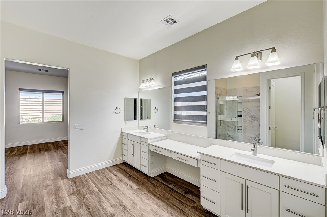 8197 Riley Love Street Las Vegas, NV 89139 - Photo 34 of 48 A generously sized primary bathroom features dual vanities and sleek modern finishes, ideal for a peaceful morning routine.